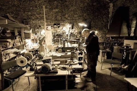 Baptiste, knife maker at L'Âme de Six, at his workshop bench